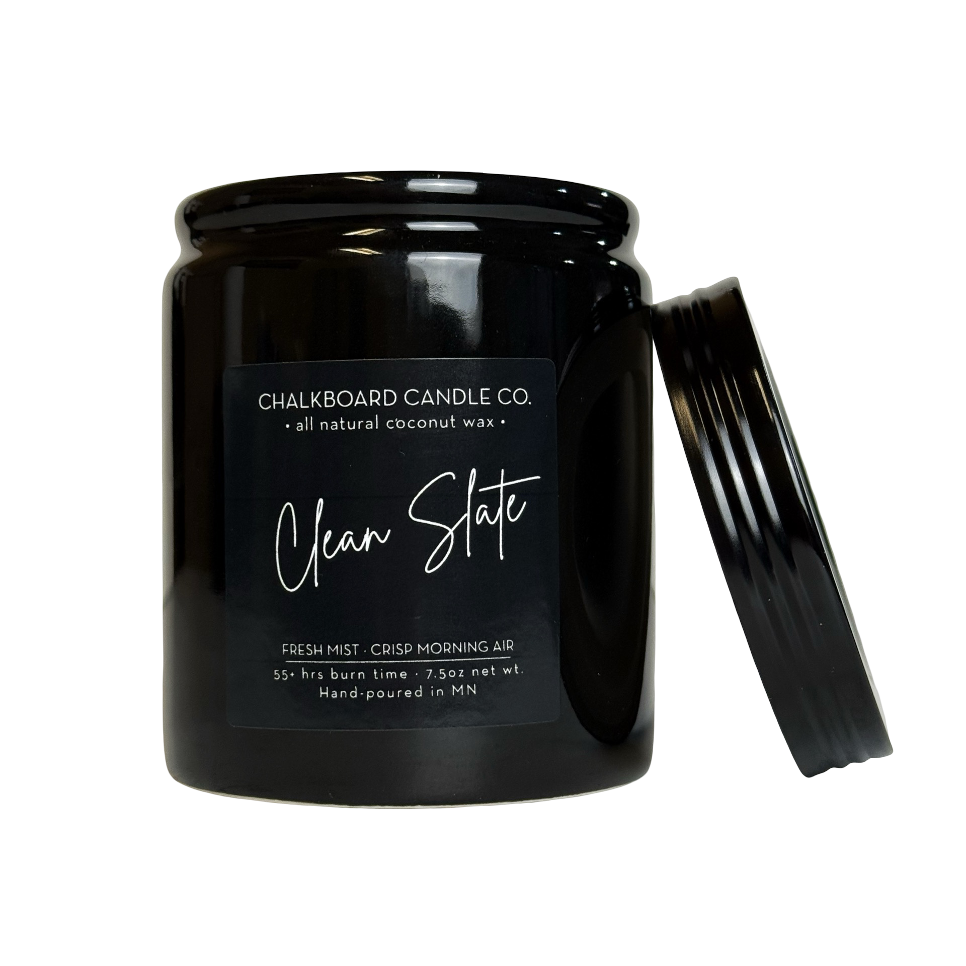 Black jar candle (Chalkboard Candle Co.) labeled 'Clean Slate' with lid leaning against the jar